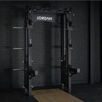 A black Jordan J75 Cable Rack integrated dual pulley system with accessories, including J-Hooks and a multi-handle pull-up bar, designed for cable and free weight workouts.