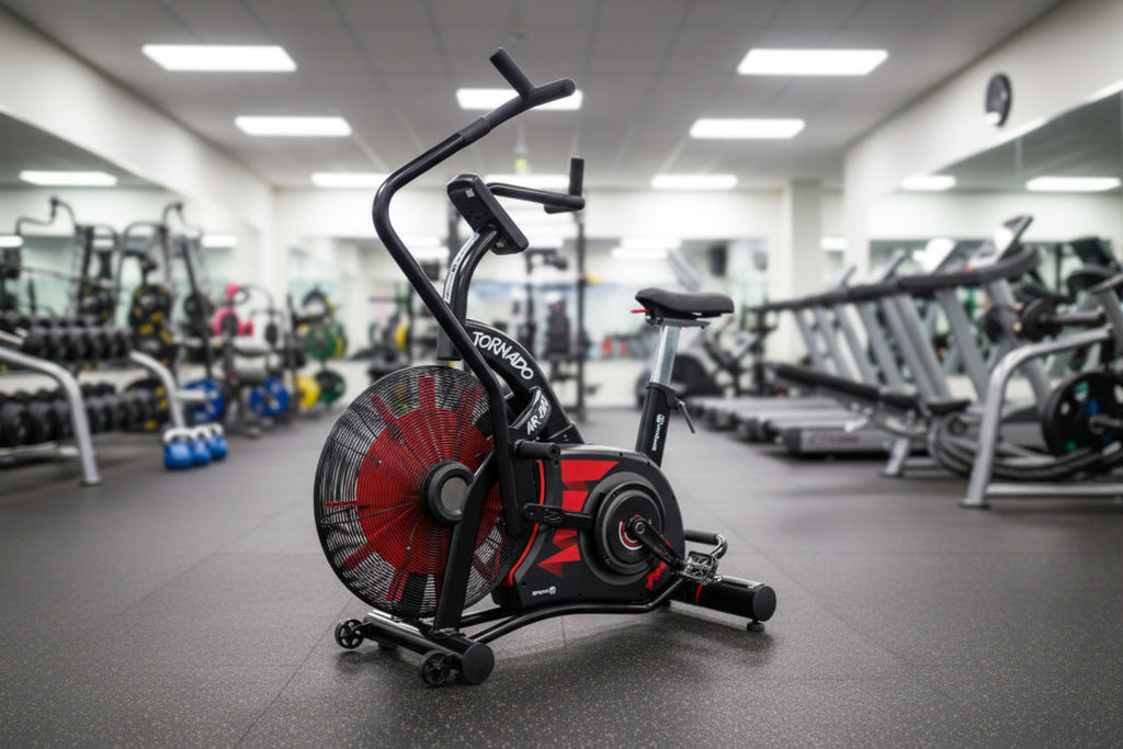 A red and black GymGear Tornado Airbike exercise bike with a large fan resistance system, a black seat, and an LCD display.